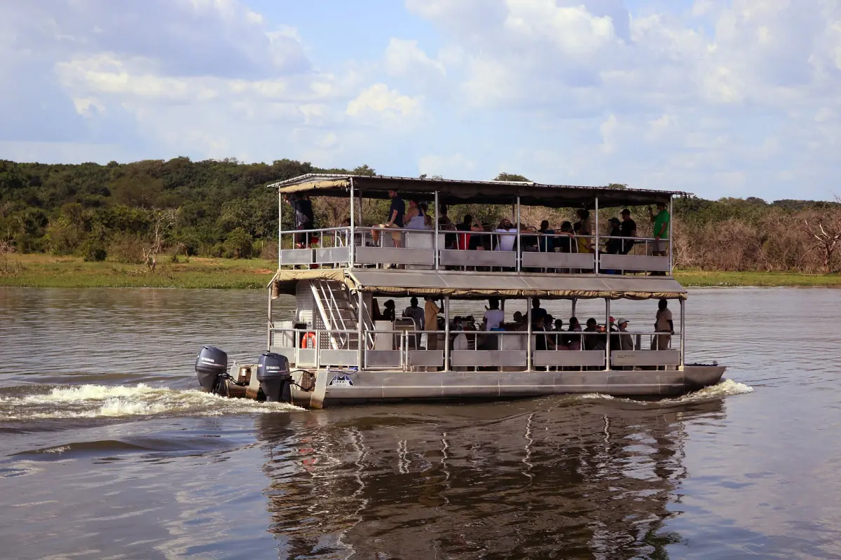 A tourist boat on the Nile with passengers on the open upper deck